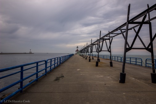 pier, railing, catwalk, lighthouse in distance